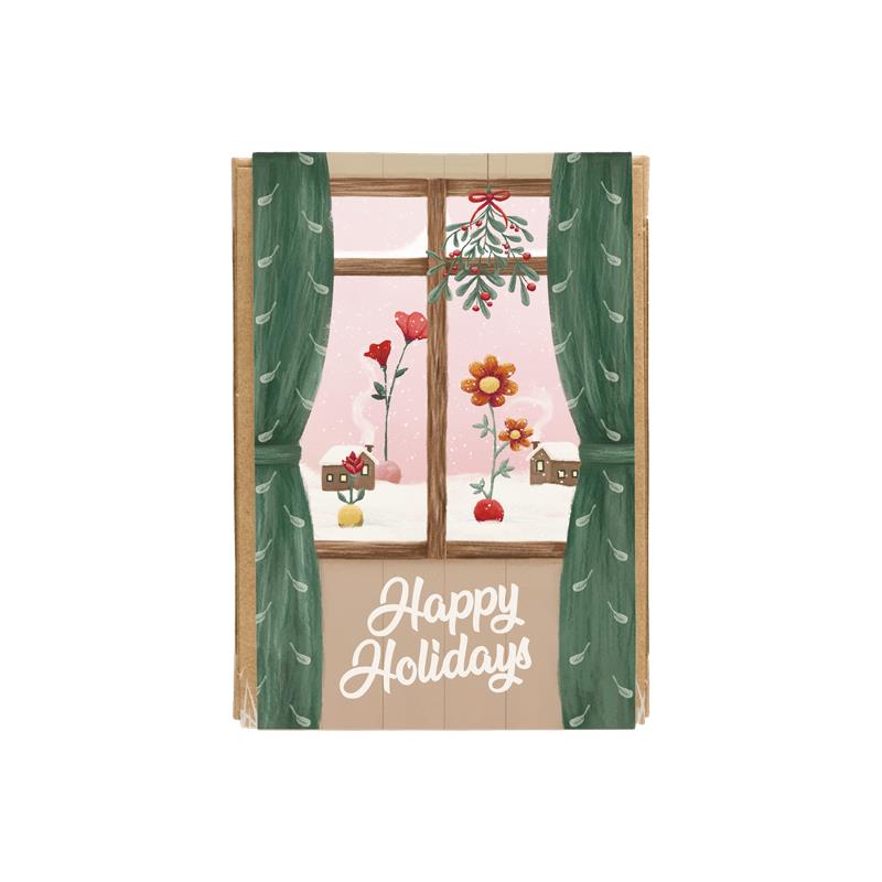 Happy Holidays Gift Box with Window art looking out onto snowy grounds with two balls on top of the snow growing colorful wildflowers and cozy homes in the distance.